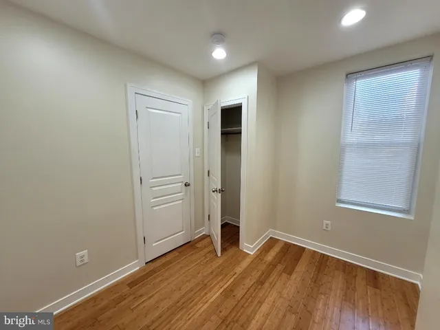 a bathroom with a granite countertop sink a toilet and bathtub