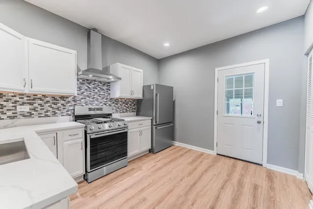 a kitchen with a refrigerator stove and sink