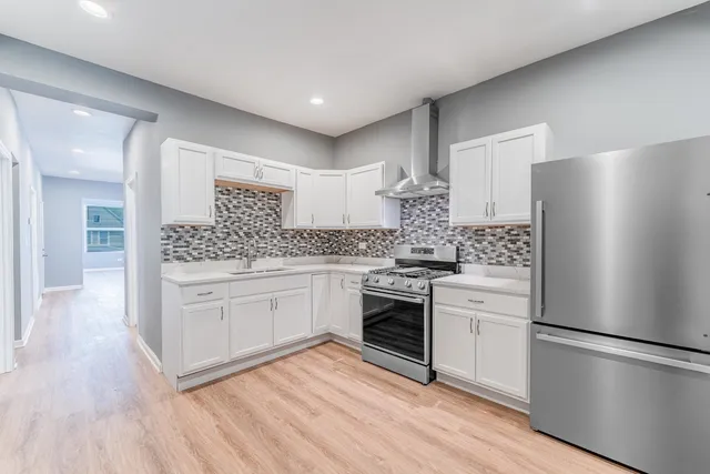 a kitchen with stainless steel appliances a refrigerator sink and cabinets