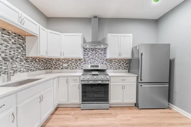 a kitchen with a stove a sink and a refrigerator
