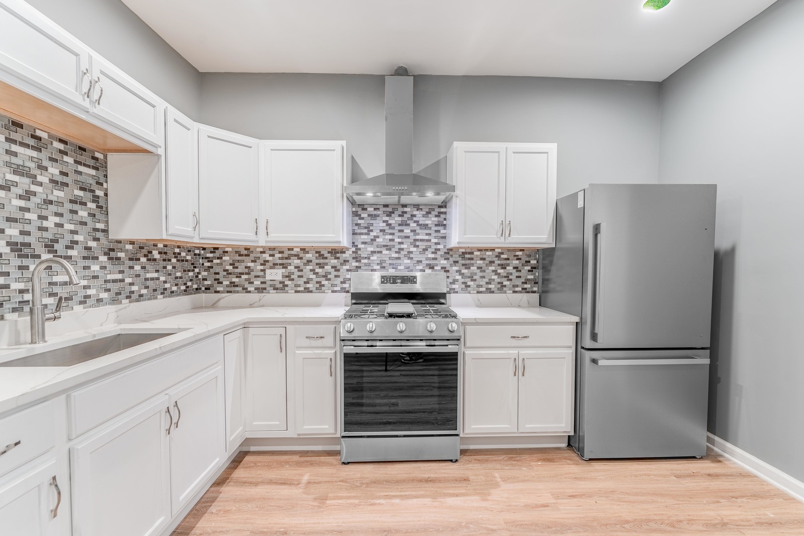 5025 West Huron Street, Unit 2 Chicago, IL 60644 - Photo 19 of 20 a kitchen with stainless steel appliances a refrigerator sink and cabinets