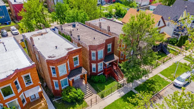 an aerial view of multiple houses with yard