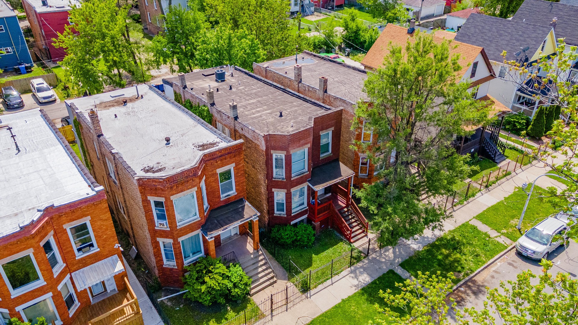 5025 West Huron Street, Unit 2 Chicago, IL 60644 - Photo 3 of 20 an aerial view of multiple houses with yard