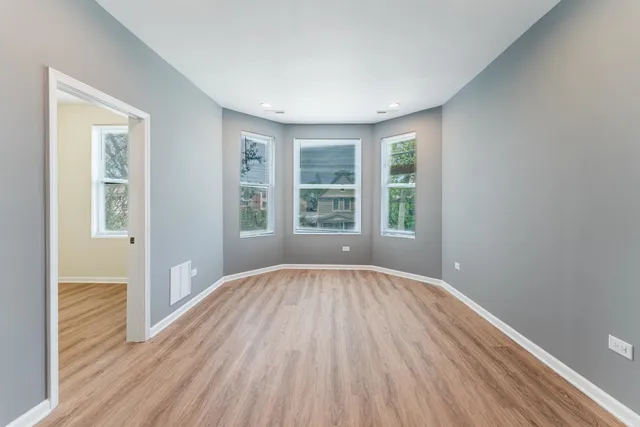 a view of a room with wooden floor