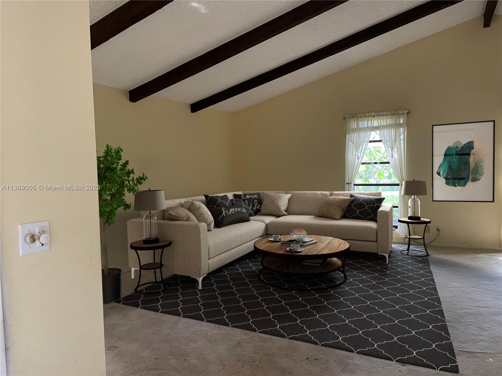 6848 Tiburon Drive Boca Raton, FL 33433 - Photo 3 of 12 a living room with a couch and a potted plant on a coffee table