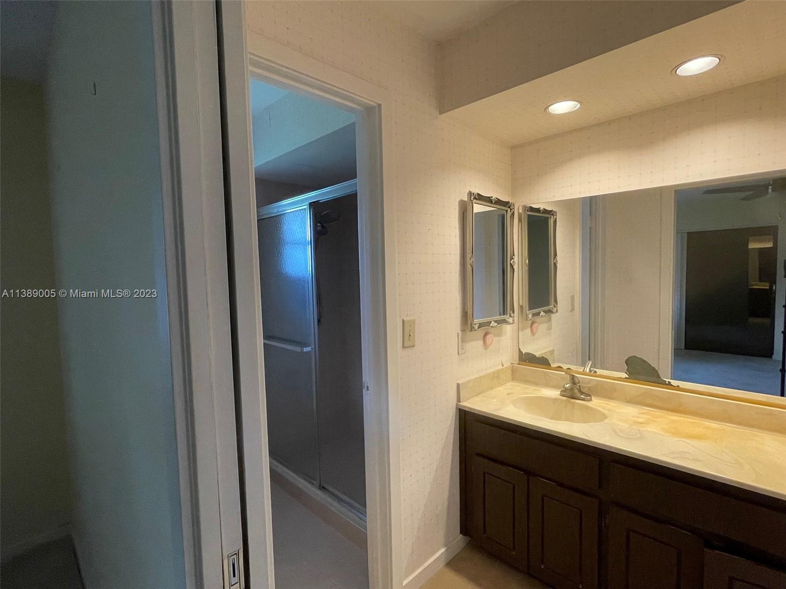 6848 Tiburon Drive Boca Raton, FL 33433 - Photo 8 of 12 a bathroom with a sink and a mirror