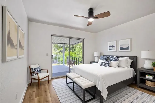 a bedroom with a bed a couch and a window