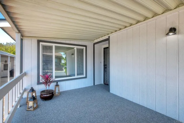 a view of a big room with wooden floor and windows