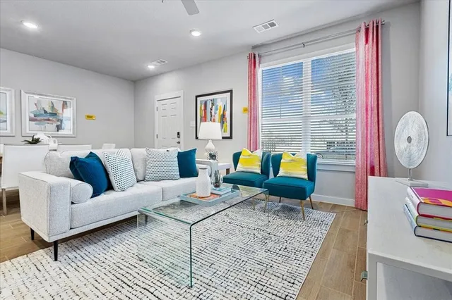 a living room with furniture a rug and a window