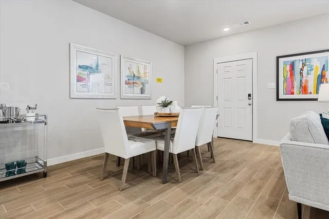 a dining room with furniture and wooden floor