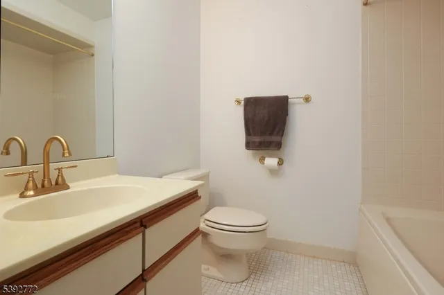 a bathroom with a sink toilet and mirror