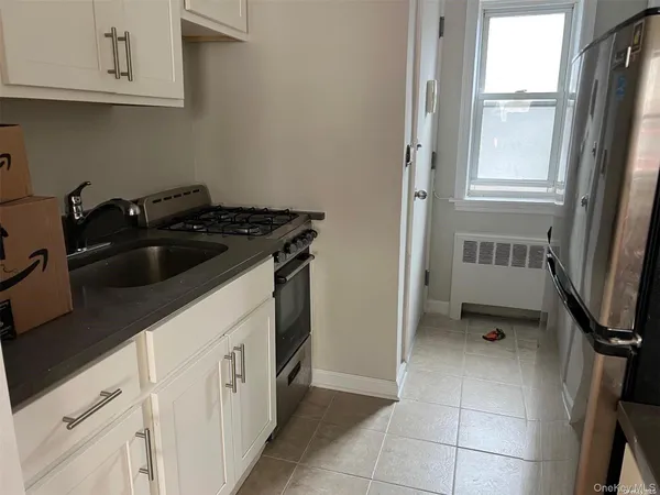 a kitchen with white cabinets and a sink