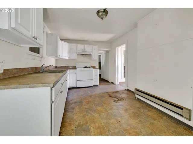 a kitchen with a sink stove and cabinets