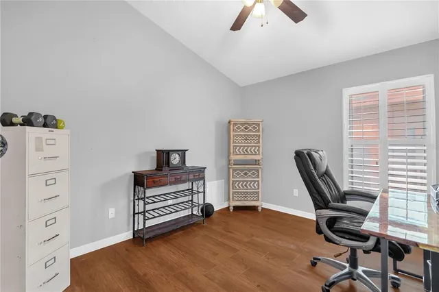 a view of a workspace with furniture and a window