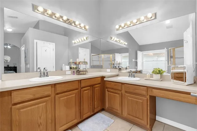 a kitchen with sink and white cabinets
