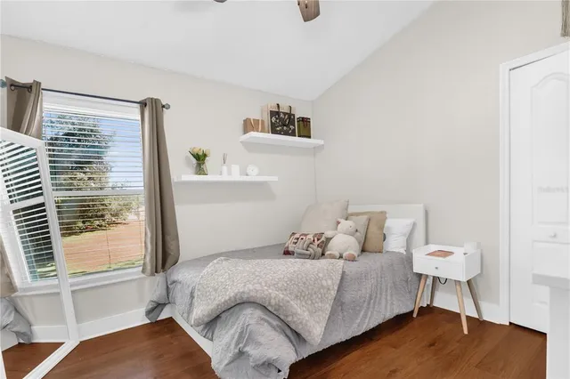 a bed sitting in a bedroom next to a window