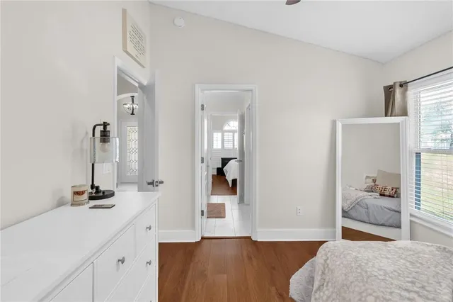 a bedroom with a bed and wooden floor