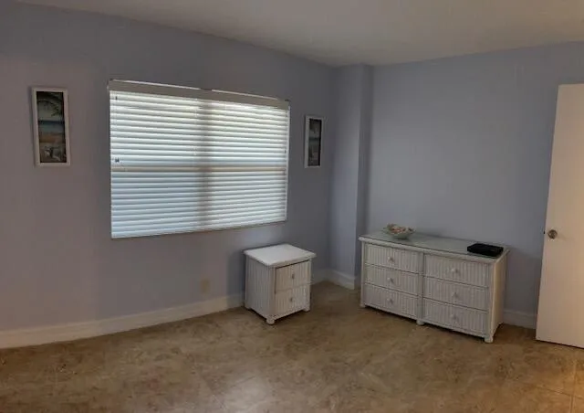 a room with a chair and a window