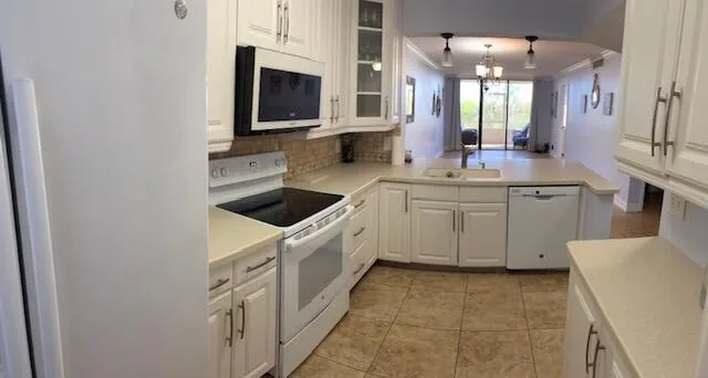 a kitchen with stainless steel appliances a sink and a microwave