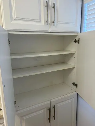 a close view of closet and wooden cabinets