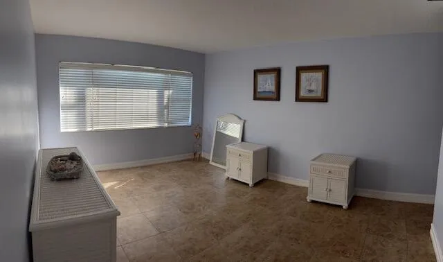 a room with a window and a table chair