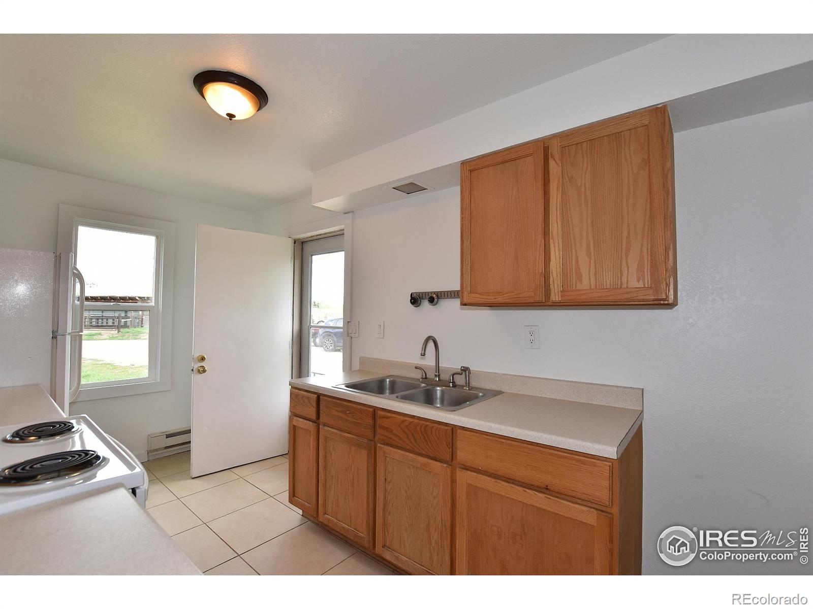 1340 North Taft Hill Road Fort Collins, CO 80521 - Photo 33 of 40 a kitchen with a sink cabinets and a window
