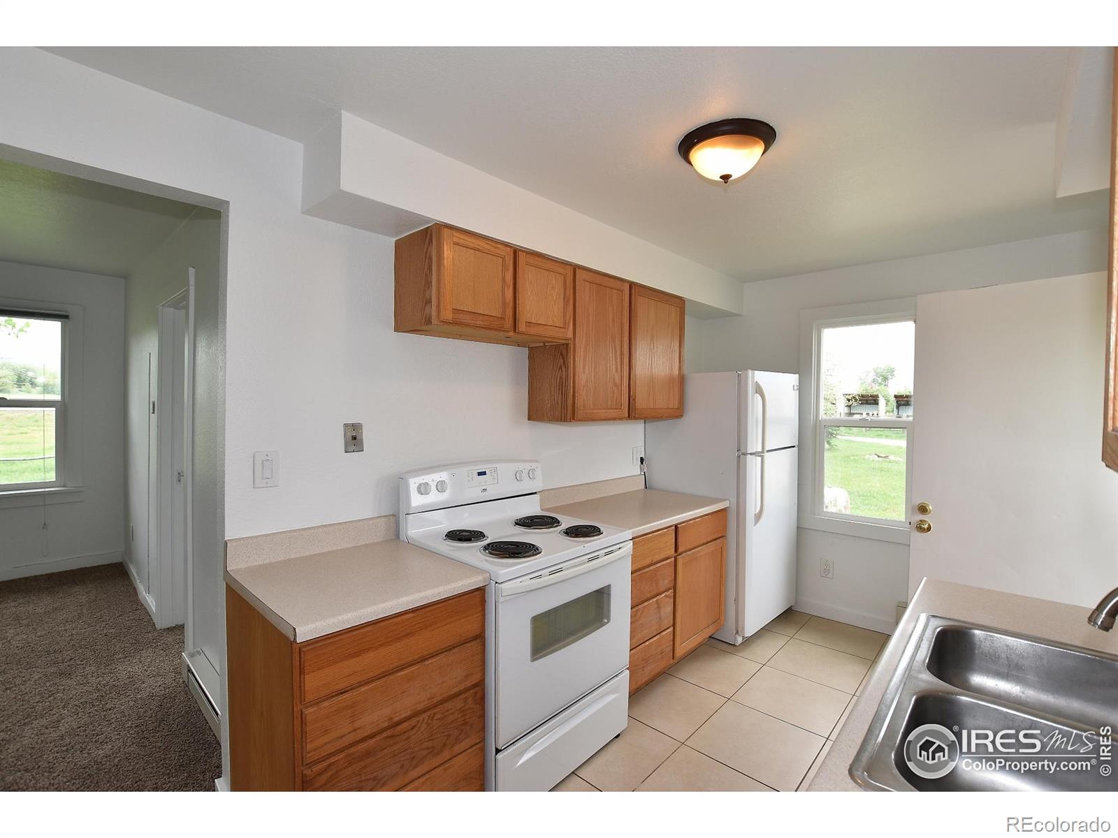 1340 North Taft Hill Road Fort Collins, CO 80521 - Photo 34 of 40 a kitchen with stainless steel appliances granite countertop a stove a sink and a refrigerator