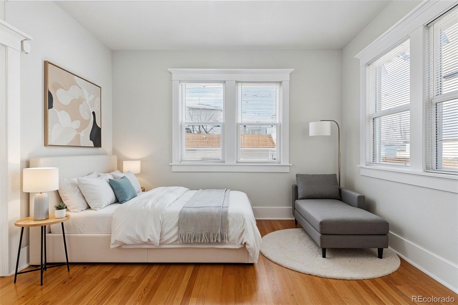 1411-1419 Meade Street Denver, CO 80204 - Photo 12 of 20 a bedroom with a bed and a couch with window