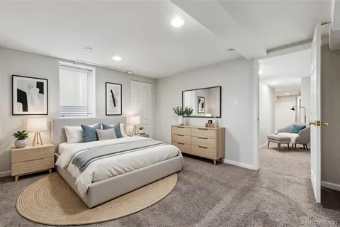 a bedroom with bed and white cabinets