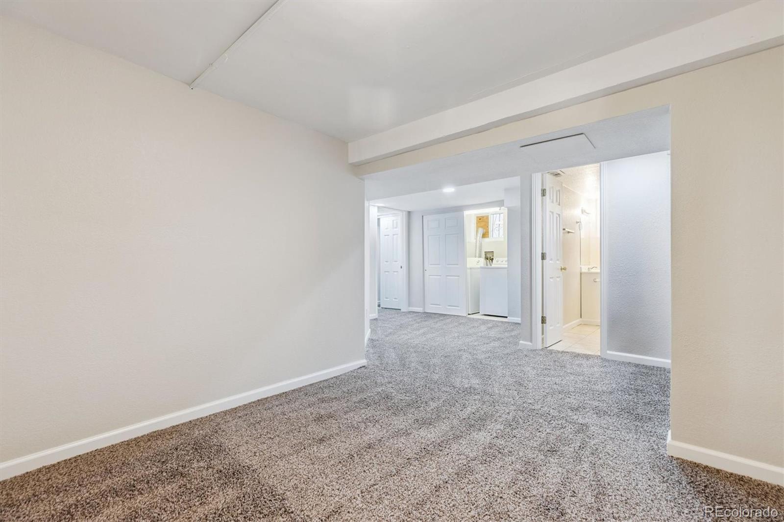 1411-1419 Meade Street Denver, CO 80204 - Photo 16 of 20 an empty room with a natural light