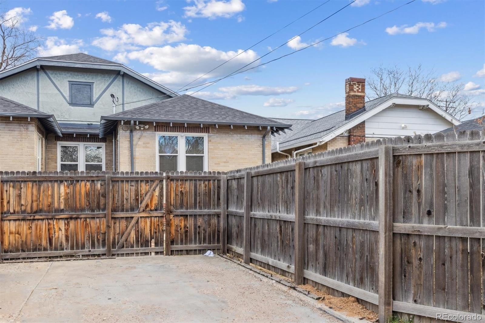1411-1419 Meade Street Denver, CO 80204 - Photo 20 of 20 a view of a brick house with a small roof deck
