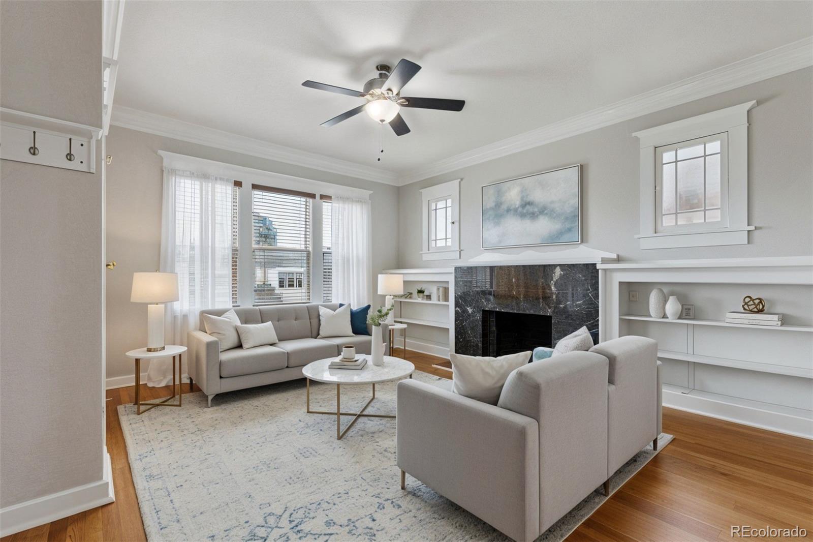 1411-1419 Meade Street Denver, CO 80204 - Photo 2 of 20 a living room with furniture and a fireplace