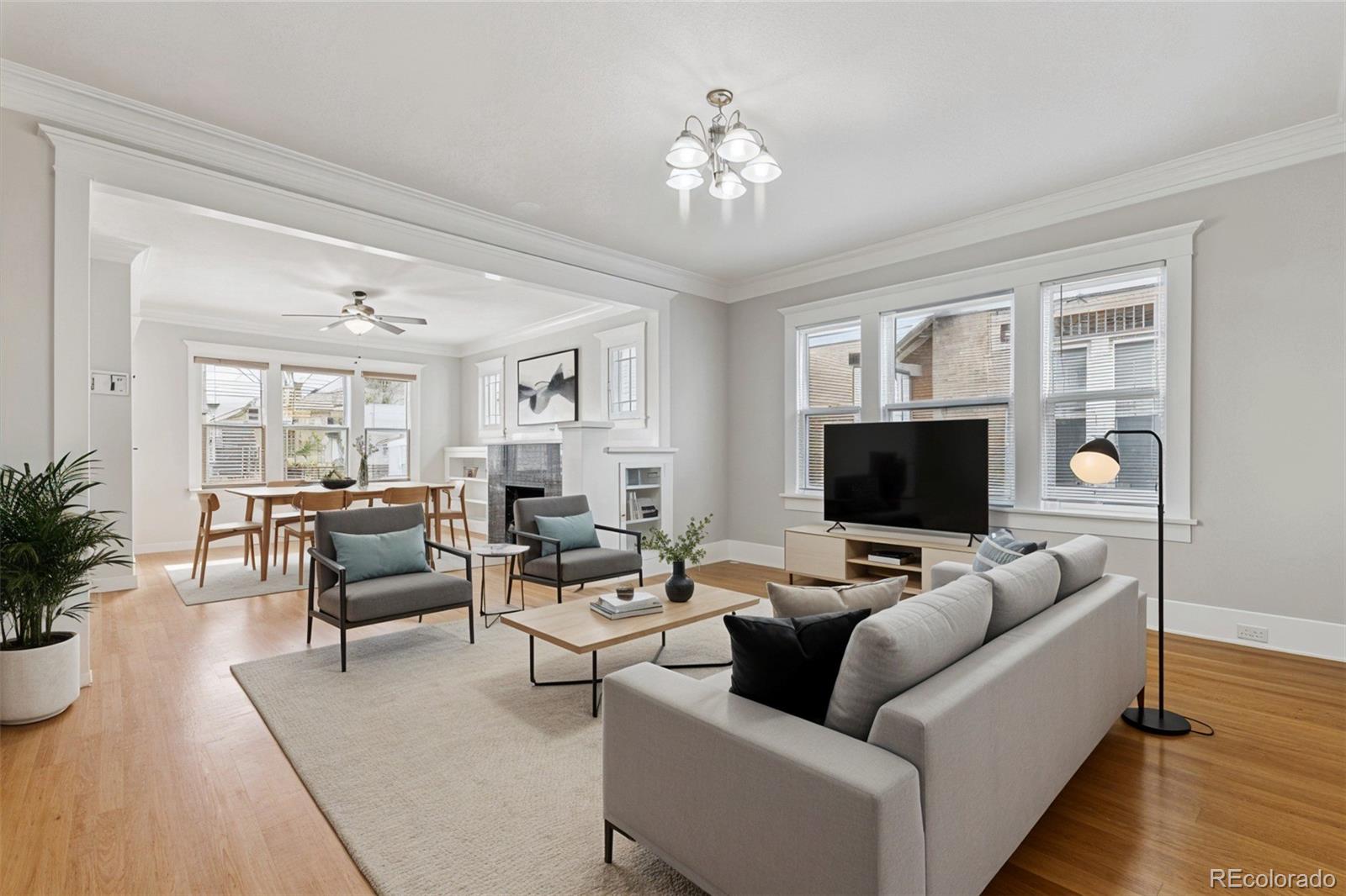 1411-1419 Meade Street Denver, CO 80204 - Photo 4 of 20 a living room with furniture and a flat screen tv