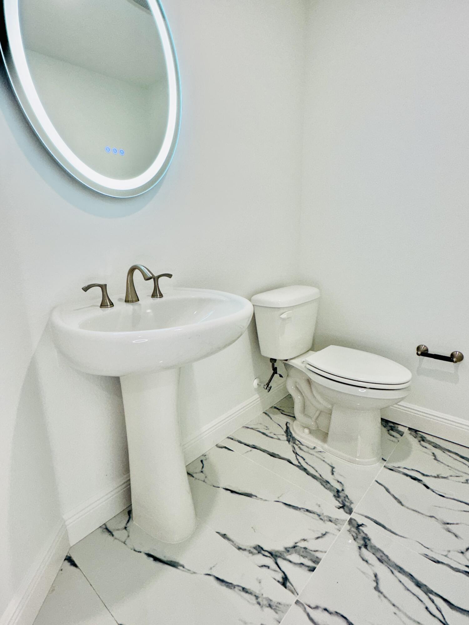 735 Pilot Lane, Unit 314 Merritt Island, FL 32952 - Photo 14 of 41 a bathroom with a sink toilet and a mirror