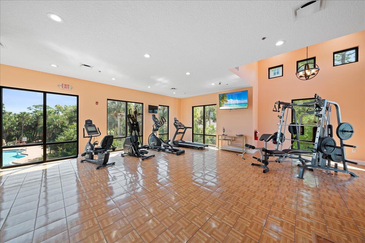 735 Pilot Lane, Unit 314 Merritt Island, FL 32952 - Photo 24 of 41 a view of a room with gym equipment and floor to ceiling window