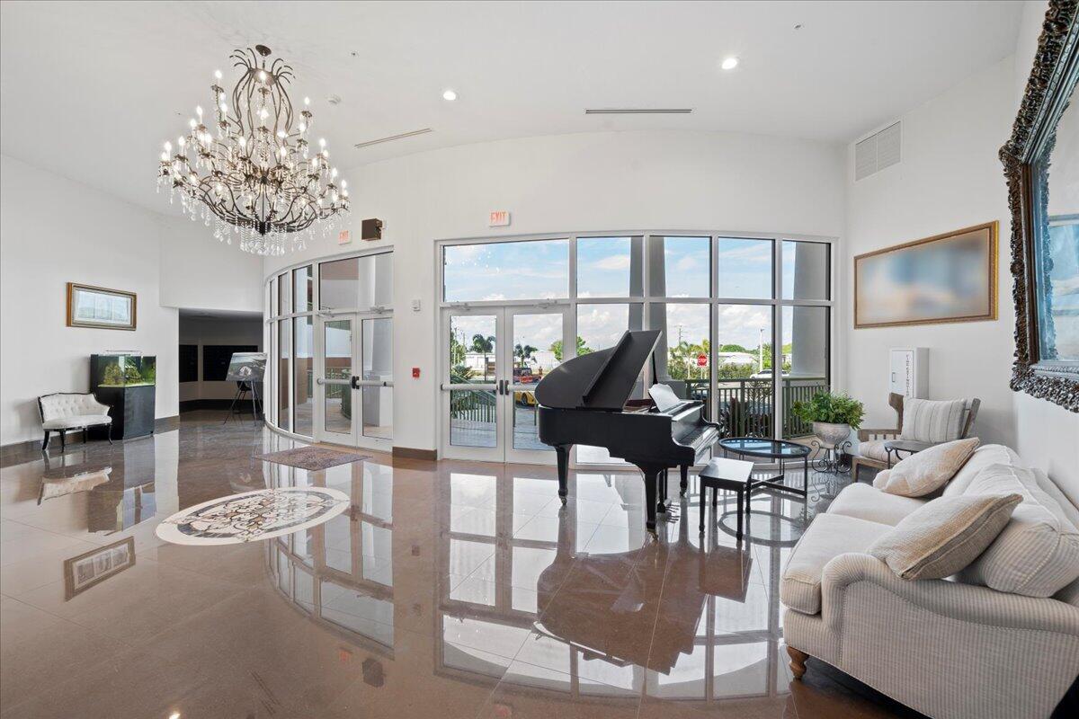 735 Pilot Lane, Unit 314 Merritt Island, FL 32952 - Photo 7 of 41 a living room with furniture a chandelier and a floor to ceiling window