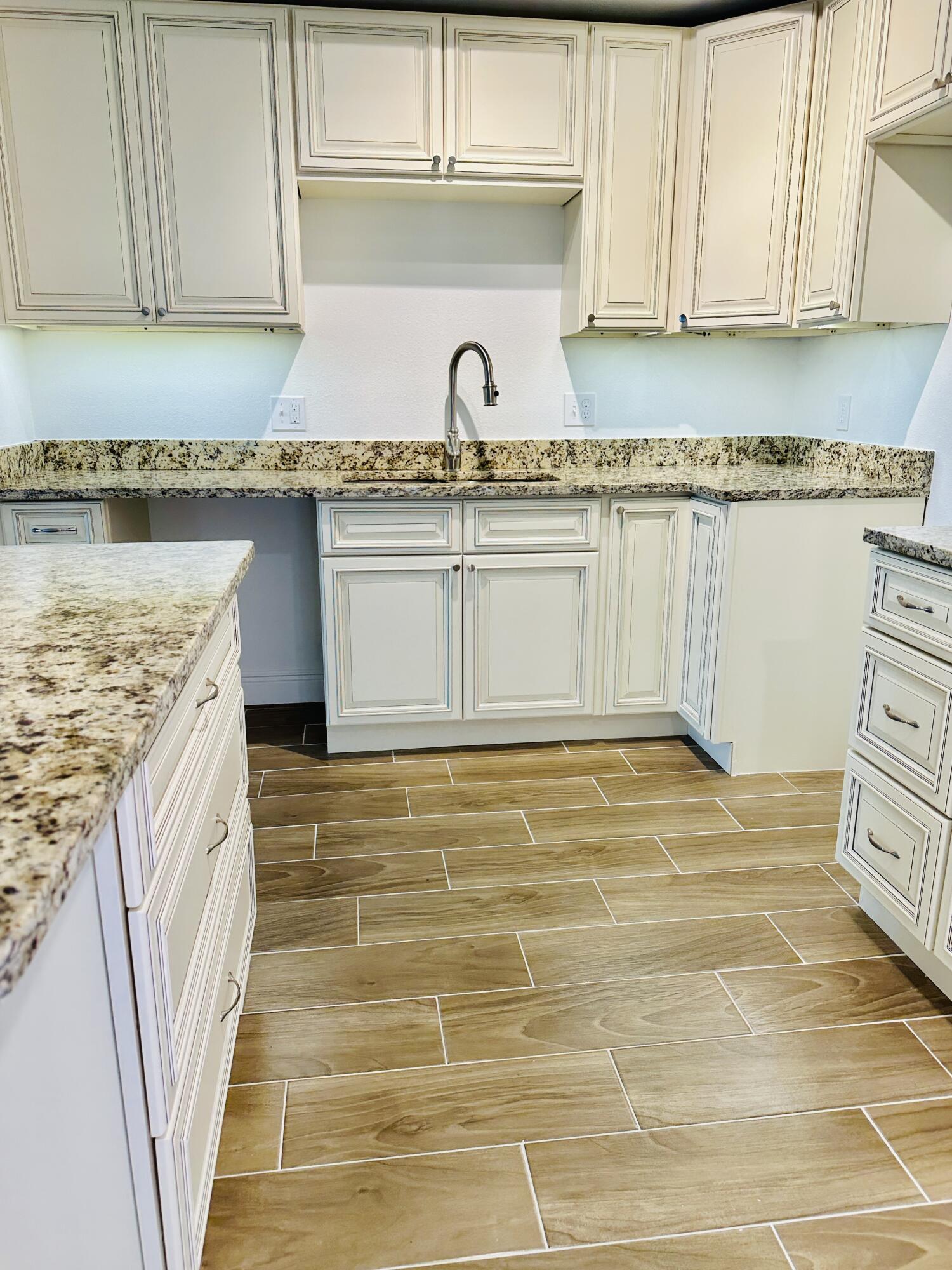735 Pilot Lane, Unit 314 Merritt Island, FL 32952 - Photo 8 of 41 a kitchen with granite countertop a sink a stove and cabinets