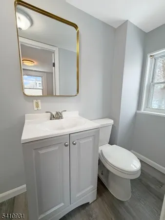 a bathroom with a sink mirror and toilet