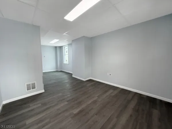 a view of an empty room and wooden floor