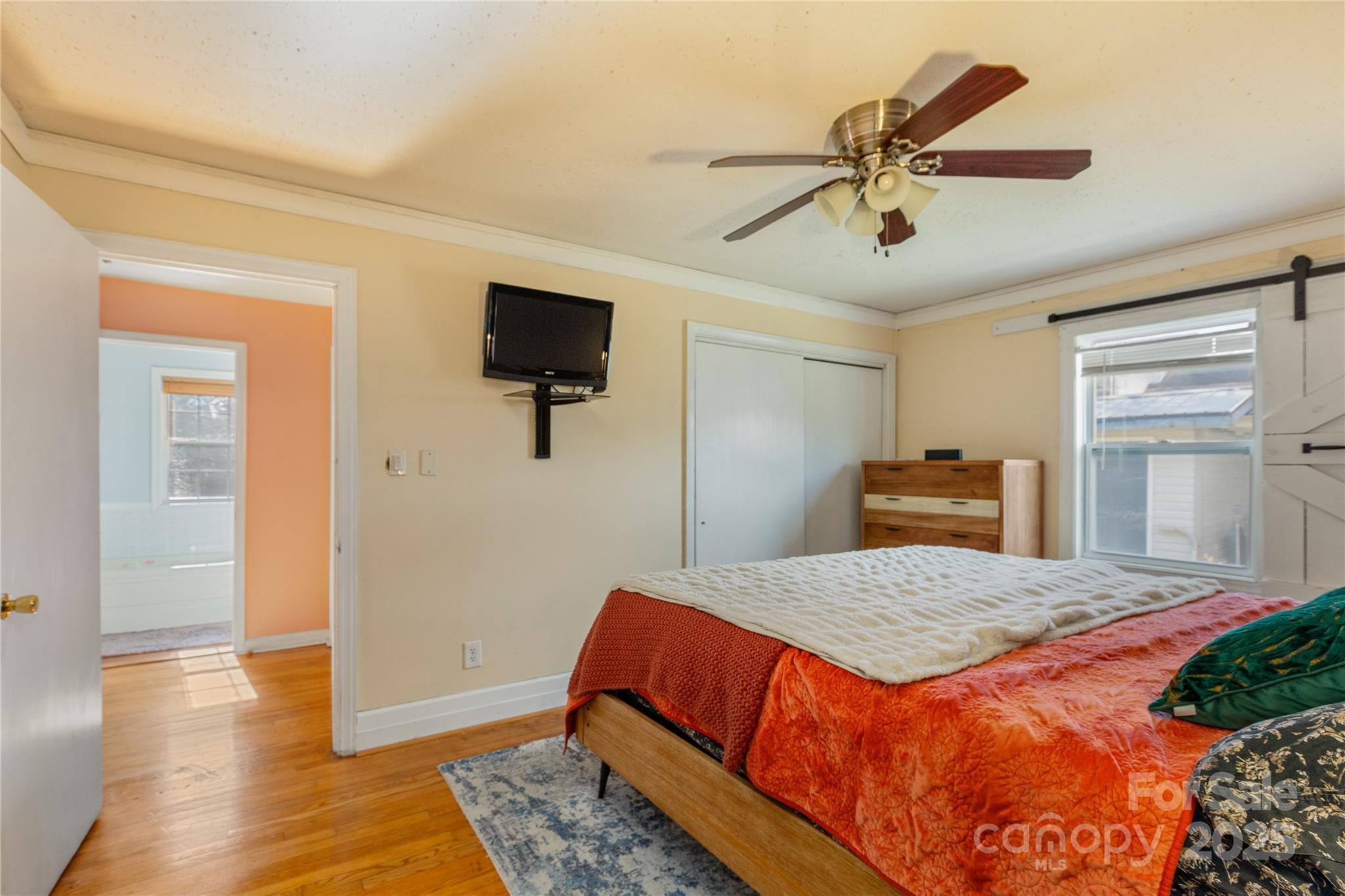 333 Oakview Park Road Asheville, NC 28803 - Photo 11 of 31 a bedroom with a bed and a flat screen tv