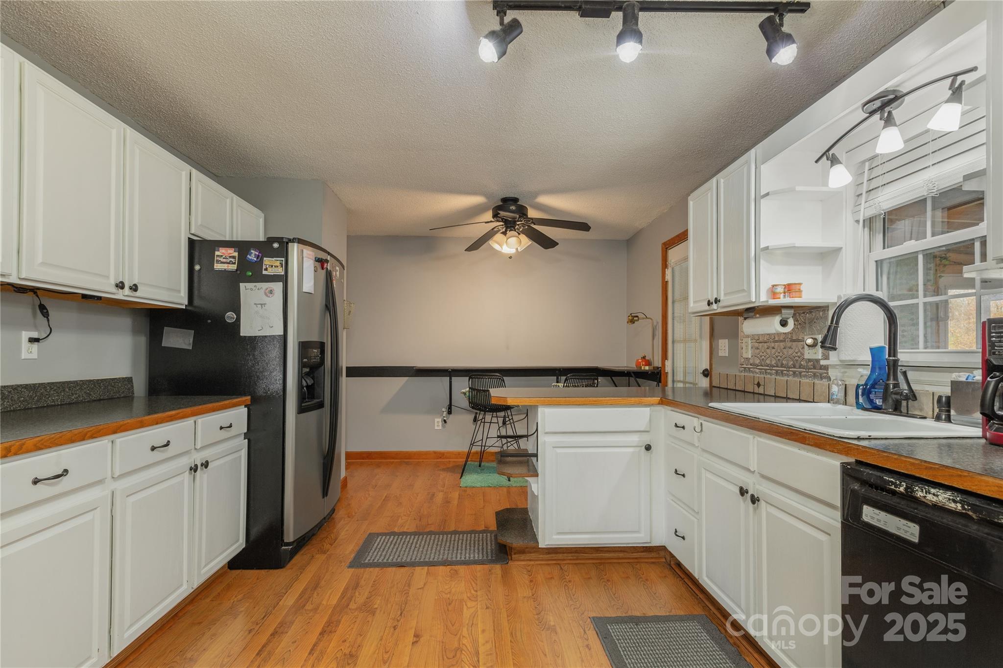 333 Oakview Park Road Asheville, NC 28803 - Photo 4 of 31 a kitchen with white cabinets and appliances