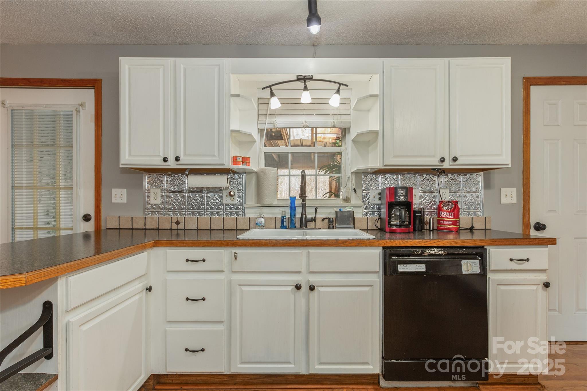 333 Oakview Park Road Asheville, NC 28803 - Photo 7 of 31 a kitchen with white cabinets and sink
