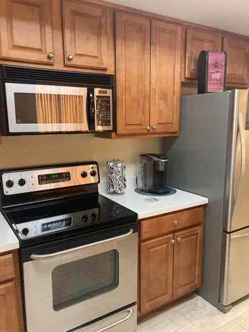 a kitchen with a sink a stove and cabinets