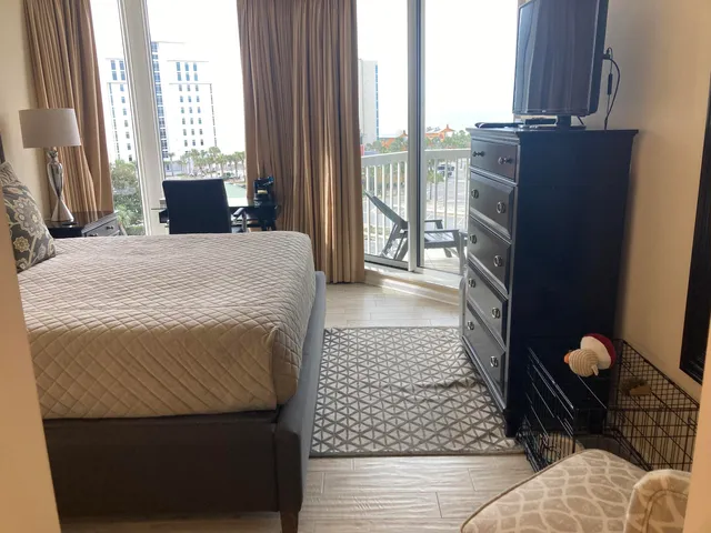 a bedroom with a bed and a television