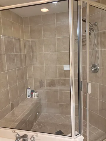 a bathroom with a bathtub and a shower
