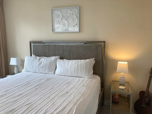 a bedroom with a bed and a large window