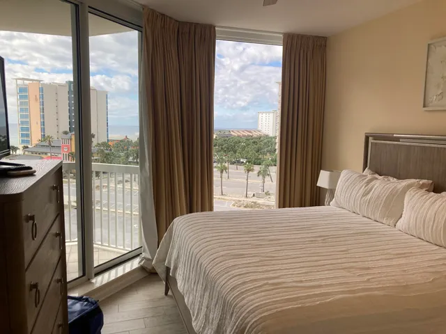 a bedroom with a bed and a flat tv screen