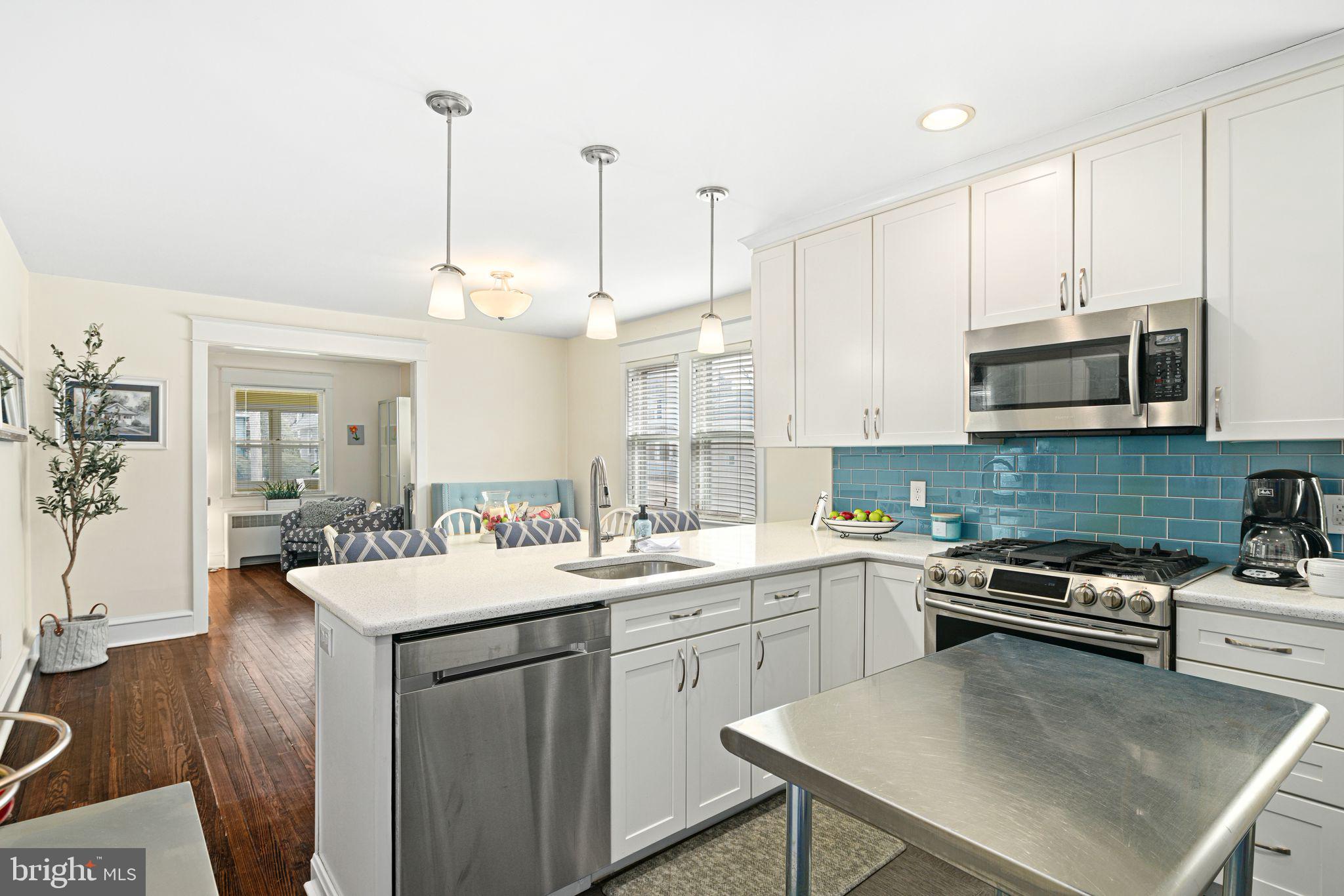 23 Ormond Avenue Haddon Township, NJ 08107 - Photo 12 of 34 a kitchen with a sink a stove and chairs