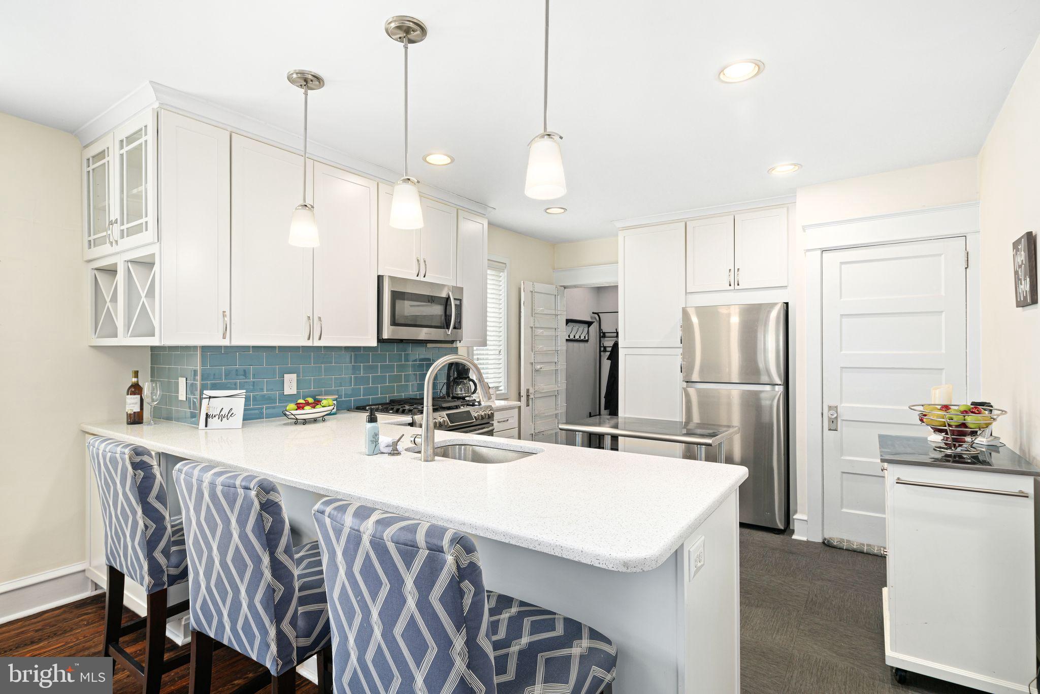 23 Ormond Avenue Haddon Township, NJ 08107 - Photo 9 of 34 a kitchen with stainless steel appliances granite countertop a sink a stove a refrigerator a center island and cabinets