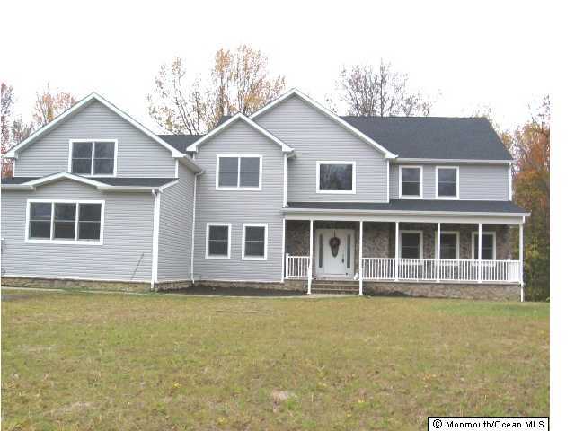 147 Millhurst Road Manalapan, NJ 07726 - Photo 1 of 3 a front view of a house with a garden